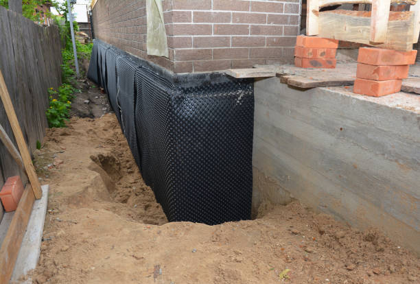 SJ Waterproofing Pros technician performing targeted Vapor Barrier Installation assessment in Bourbon, IN